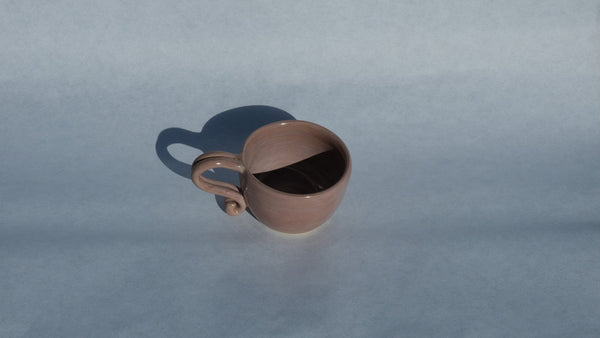 Rise Studios pink ochre stoneware cup with a glossy finish and an intricately handmade rustic bohemian handle.